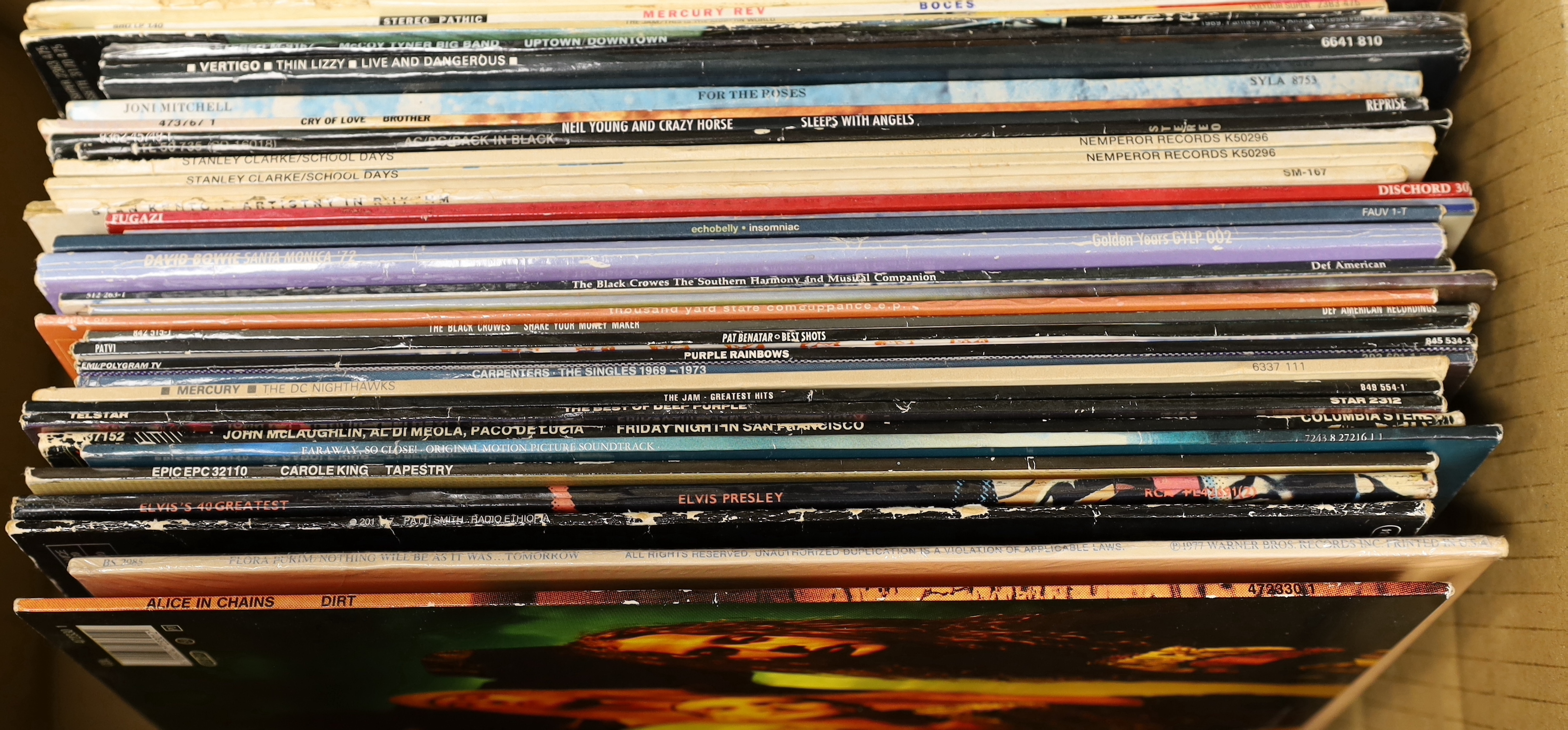Fifty-five mainly 80's and 90's LPs, including, The Jam, Joan Armatrading, Neil Young, Mercury Rev, Thin Lizzy, Joni Mitchell, AC/DC, David Bowie, The Carpenters, Alice In Chains, etc